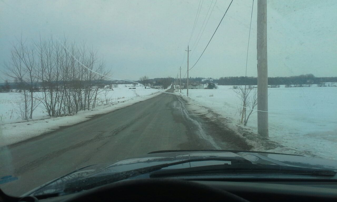 A drivers view of a country road in spring from a ford ranger