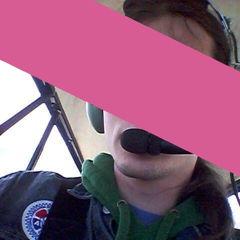 A young sysop in sits in a small airplane